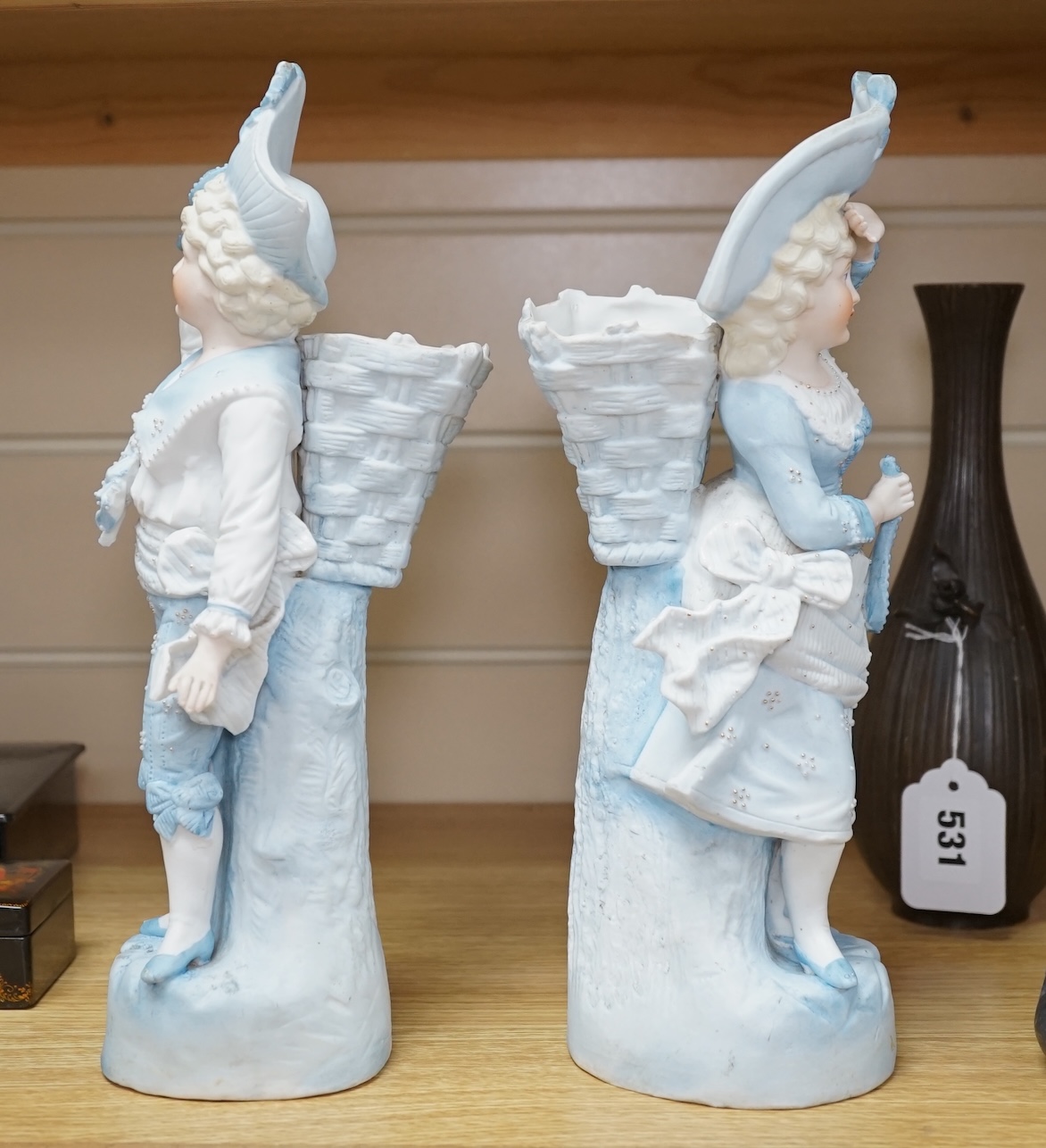 A pair of 19th century German figurative bisque spill vases, 30cm high. Condition - good